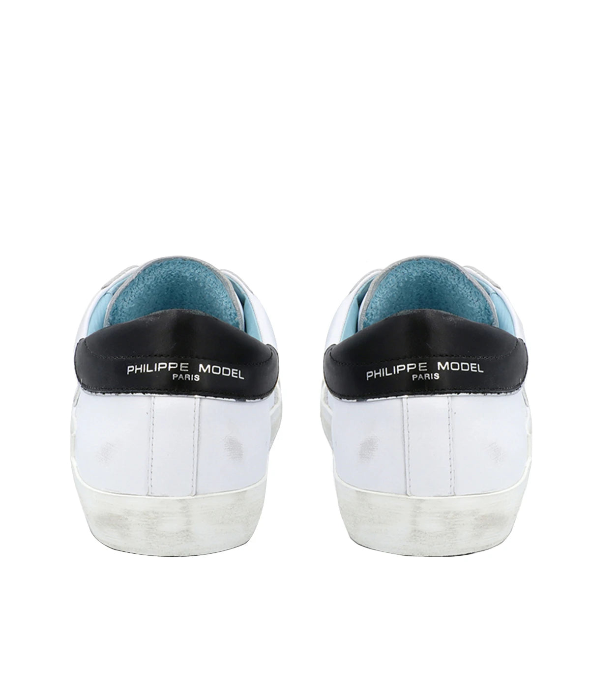 Back view of Philippe Model PRSX Low Man sneakers, highlighting the smooth, vintage-effect calfskin and suede upper. The sneakers feature a distinctive, purposefully imperfect sole created by a patented foxing tape. The shield with the City of Paris coat of arms is subtly visible on the side, adding a touch of heritage to the design.