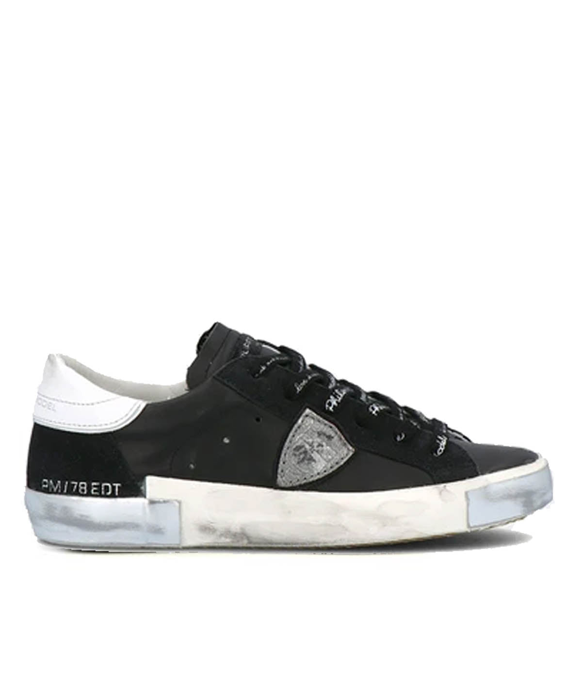 Side view of Philippe Model PRSX Low Man sneakers showcasing the unique vintage-effect design, with a patented foxing tape creating an imperfect sole. The shield on the side features the City of Paris coat of arms. The upper is crafted from high-quality Italian calfskin and suede, with laminated suede inserts