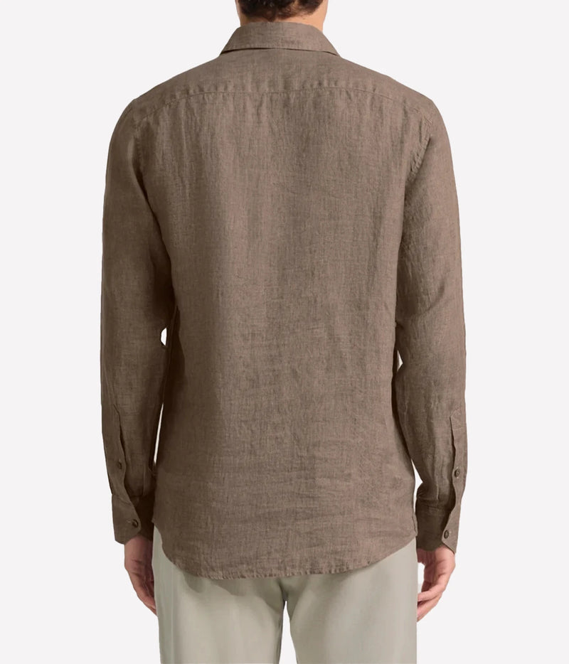 A man viewed from the back wearing a Frescobol Carioca Antonio Linen Long Sleeve Shirt in Dark Mink and light beige trousers, set against a plain light grey background.