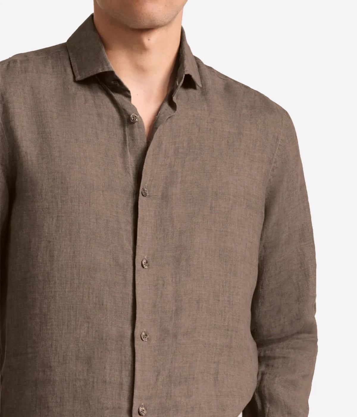 A close-up of a man wearing a Frescobol Carioca Antonio Linen Long Sleeve Shirt in Dark Mink, showing the collar, front buttons, and textured fabric against a plain white background.