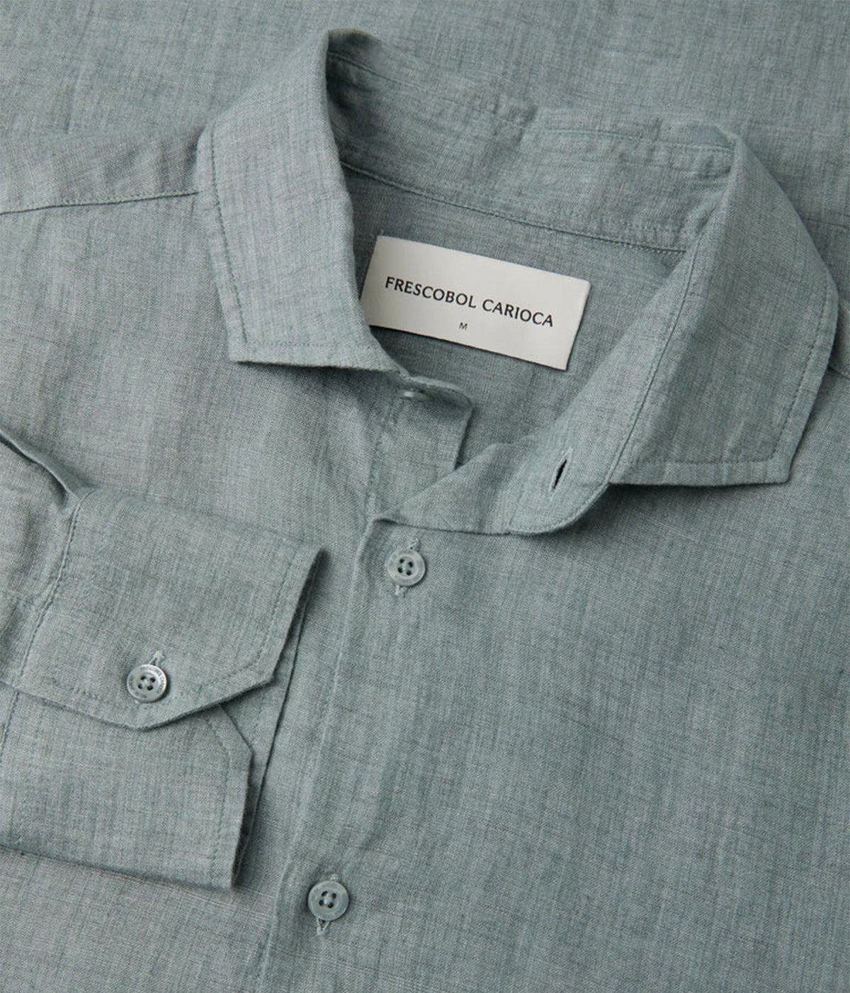 Close-up of a Frescobol Carioca Antonio Linen Long Sleeve Shirt in Ash Green, button-down front, and a visible neck label reading 'FRESCOBOL CARIACA'.