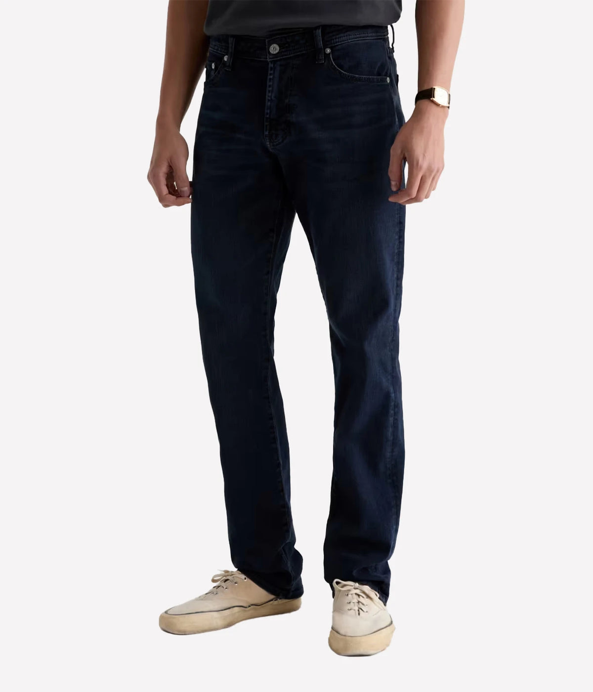 Man wearing AG Graduate Jean in Studio with a charcoal tee, three-quarter front view