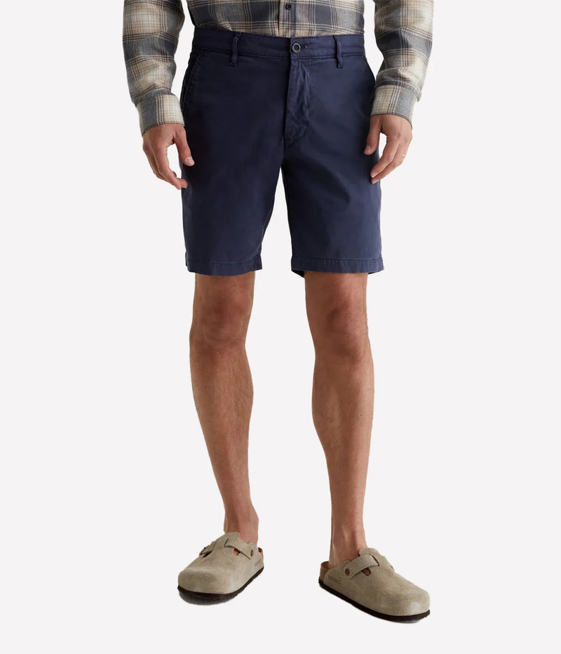 AG Wanderer Slim Fit Shorts in Sulfur Pacific Midnight (navy), featuring a sharp trouser look with a tapered leg opening. Made from ultra-lightweight cotton blend fabric for comfort. Material: 97.5% Cotton, 2.5% Elastane. Made in USA.