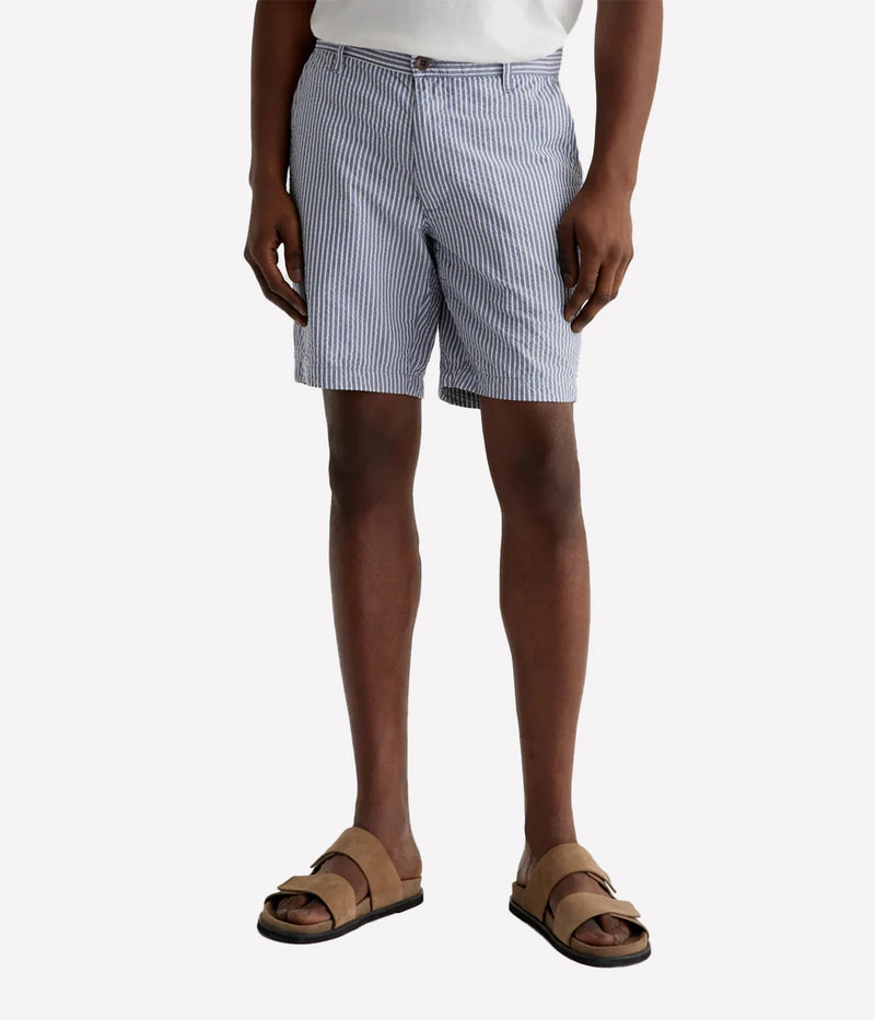 AG Wanderer Slim Fit Shorts in striped seersucker fabric, featuring a sharp trouser look with a tapered leg opening. Material: 100% Cotton. Made in USA.