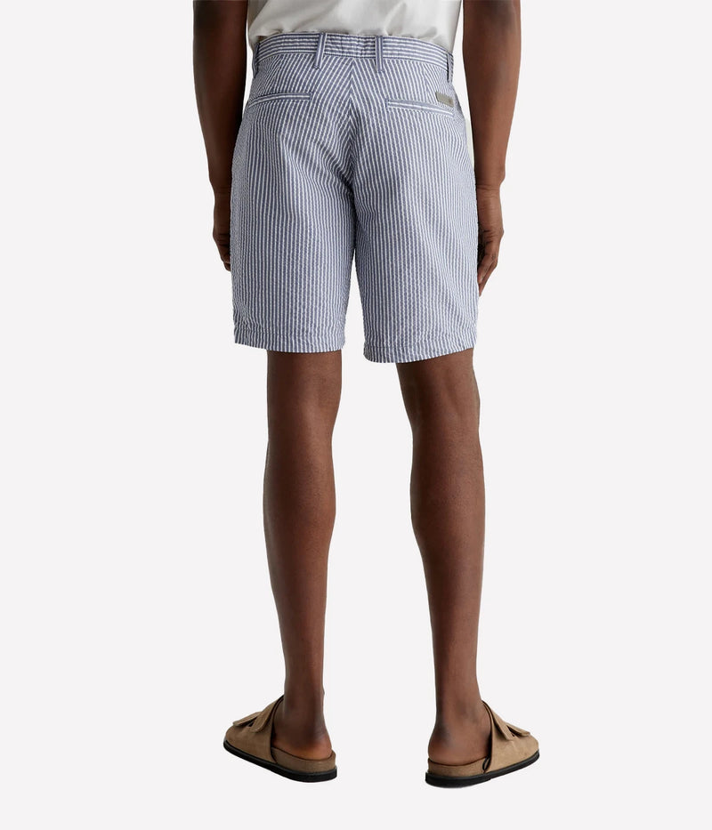 AG Wanderer Slim Fit Shorts in striped seersucker fabric, featuring a sharp trouser look with a tapered leg opening. Material: 100% Cotton. Made in USA.