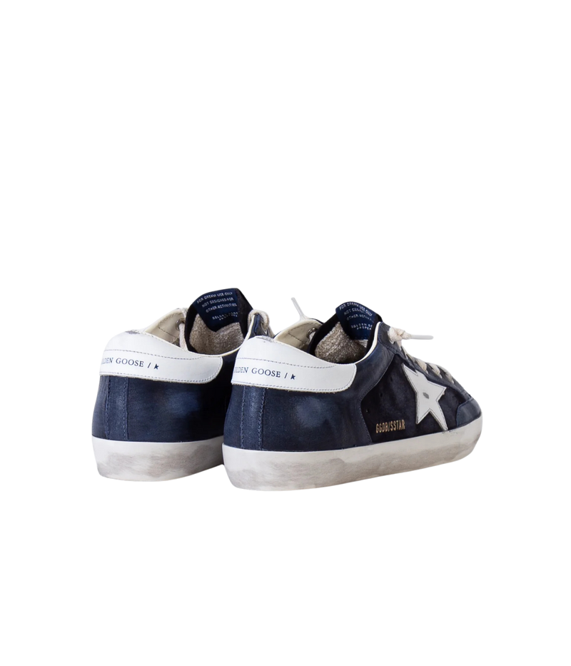 Golden Goose Super-Star Sneaker in Dark Blue & White angled back view featuring the signature leather star.