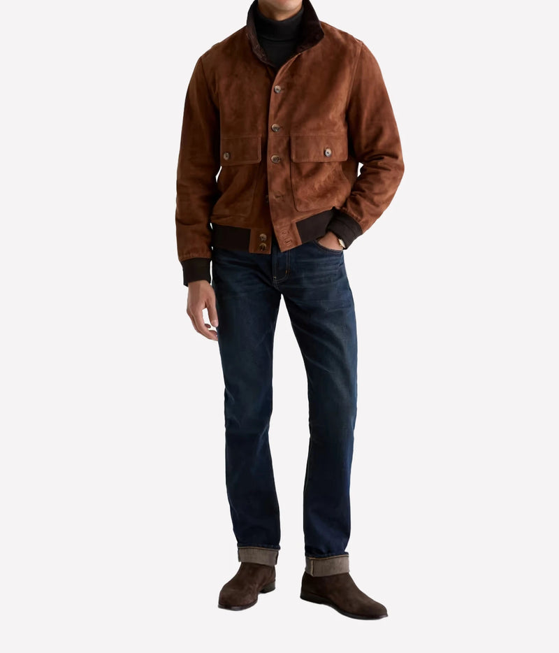 Man wearing AG Tellis Selvage Jean in 3 Years Out Of The Blue with a brown jacket and brown suede boots, front view