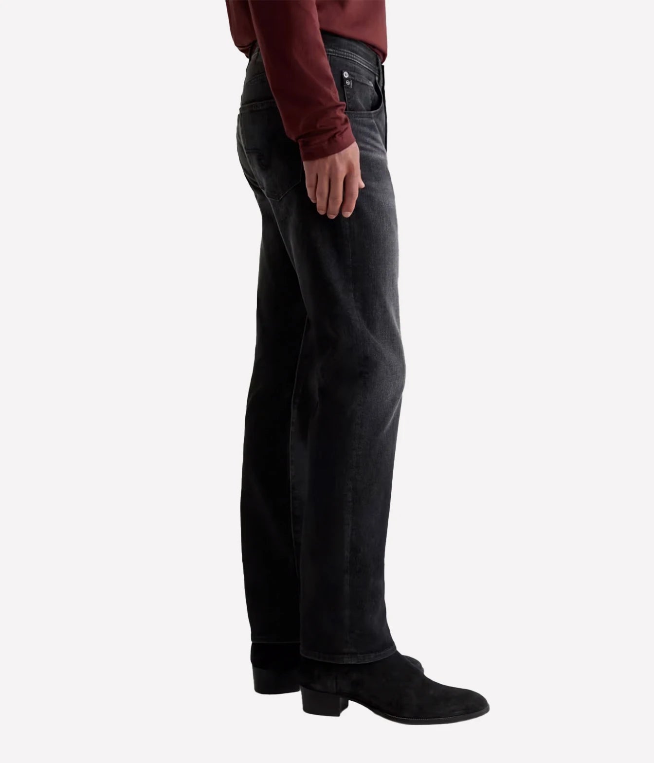 A side profile view of a person wearing black wide-leg denim jeans, a dark red long-sleeve top, and black ankle boots against a light gray background.