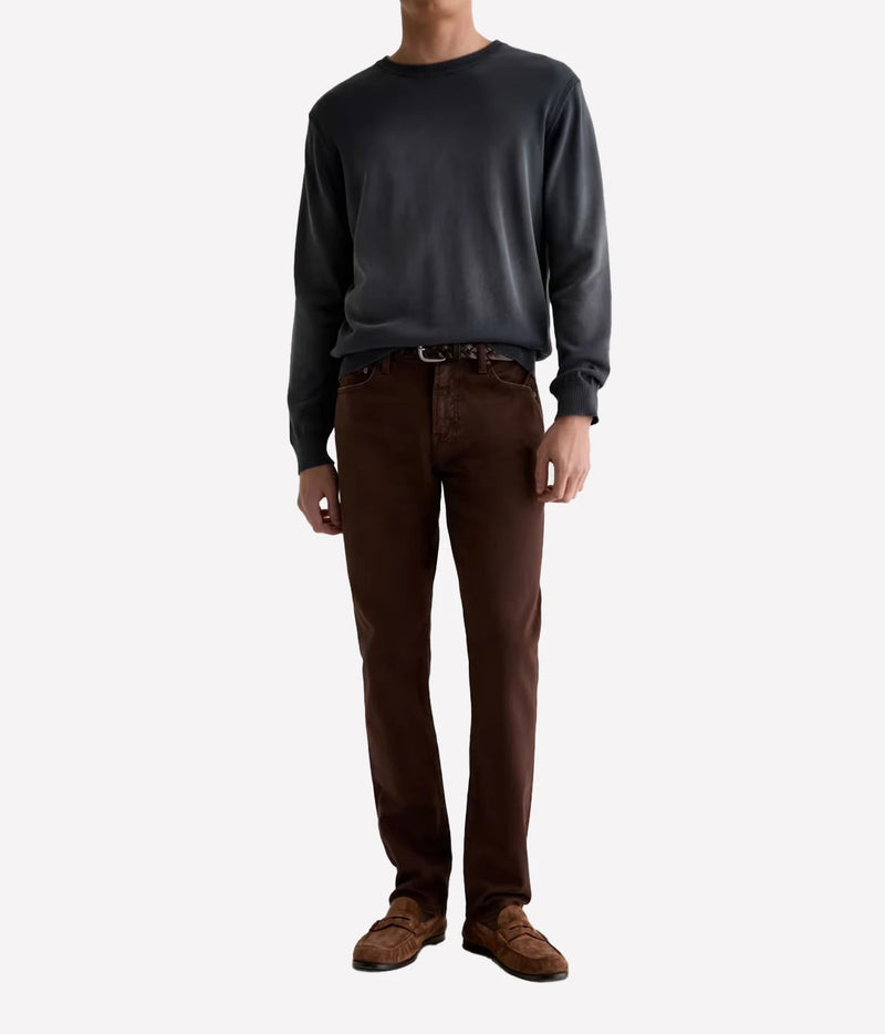 Man wearing AG Everett Jean in 7 Years Sulfur Wood Brown with a grey knit and brown shoes, full-length front view