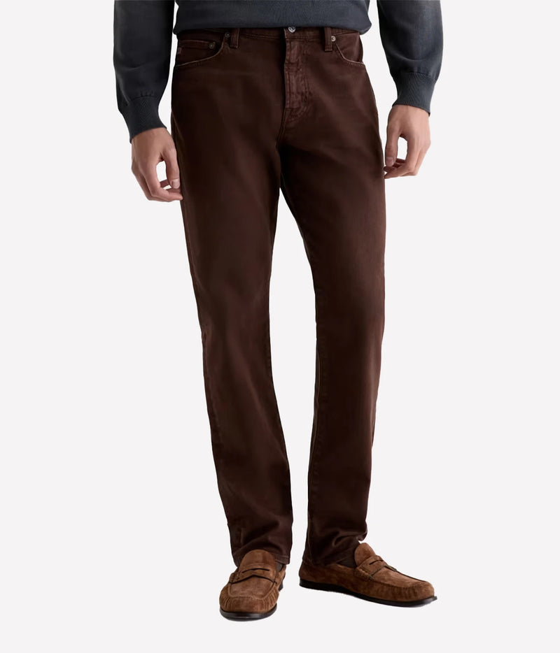 Man wearing AG Everett Jean in 7 Years Sulfur Wood Brown with a grey knit and brown shoes, front view