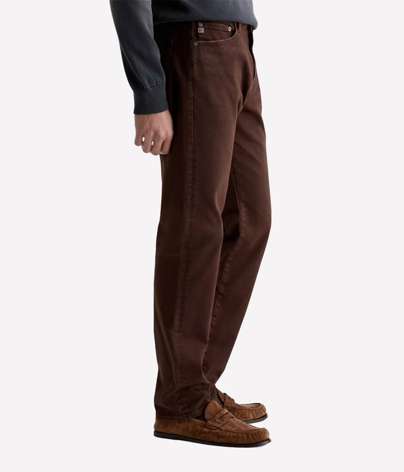 Man wearing AG Everett Jean in 7 Years Sulfur Wood Brown with brown shoes, side view