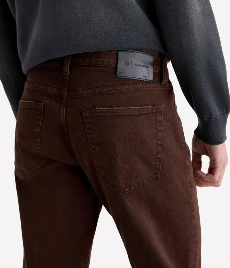 Close-up of AG Everett Jean in 7 Years Sulfur Wood Brown showing the back pockets and leather waistband patch