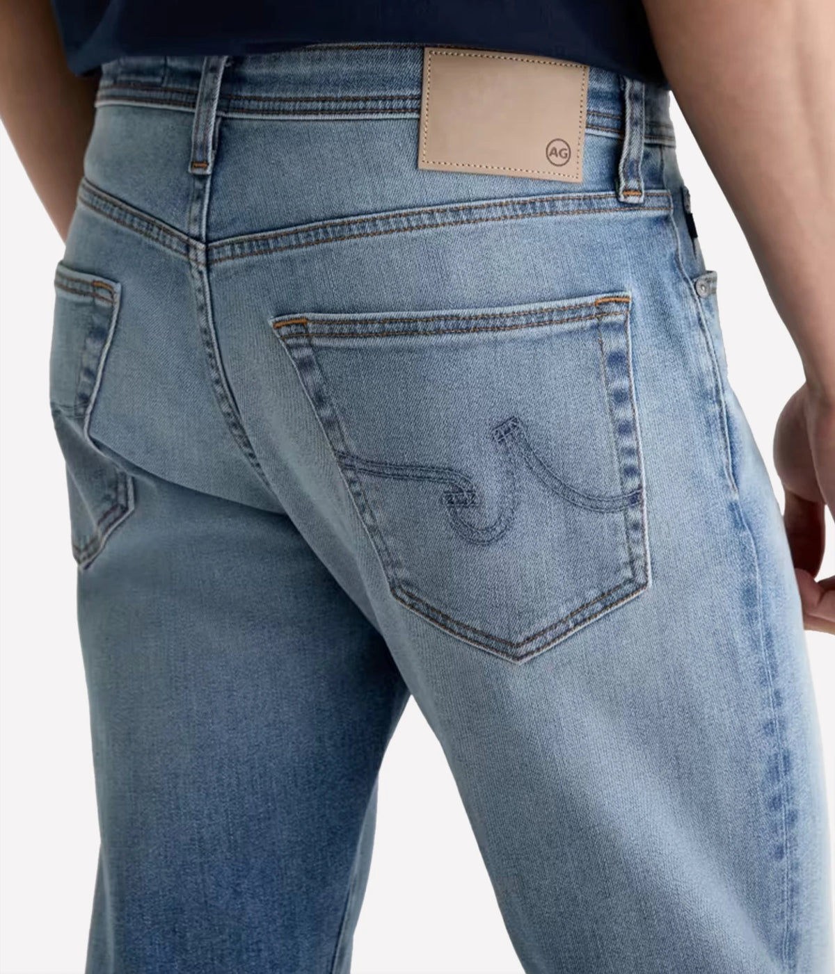 Close-up of AG Everett Jean in Watkins showing the back pocket stitching and waistband patch