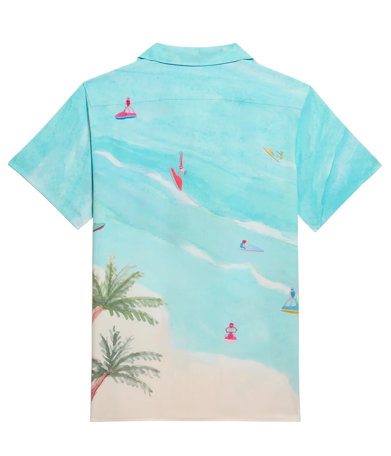 A short-sleeve camp collar shirt shown from the back, featuring a watercolor-style beach print in turquoise and light blue with palm trees, sand, and small surfers on the water.