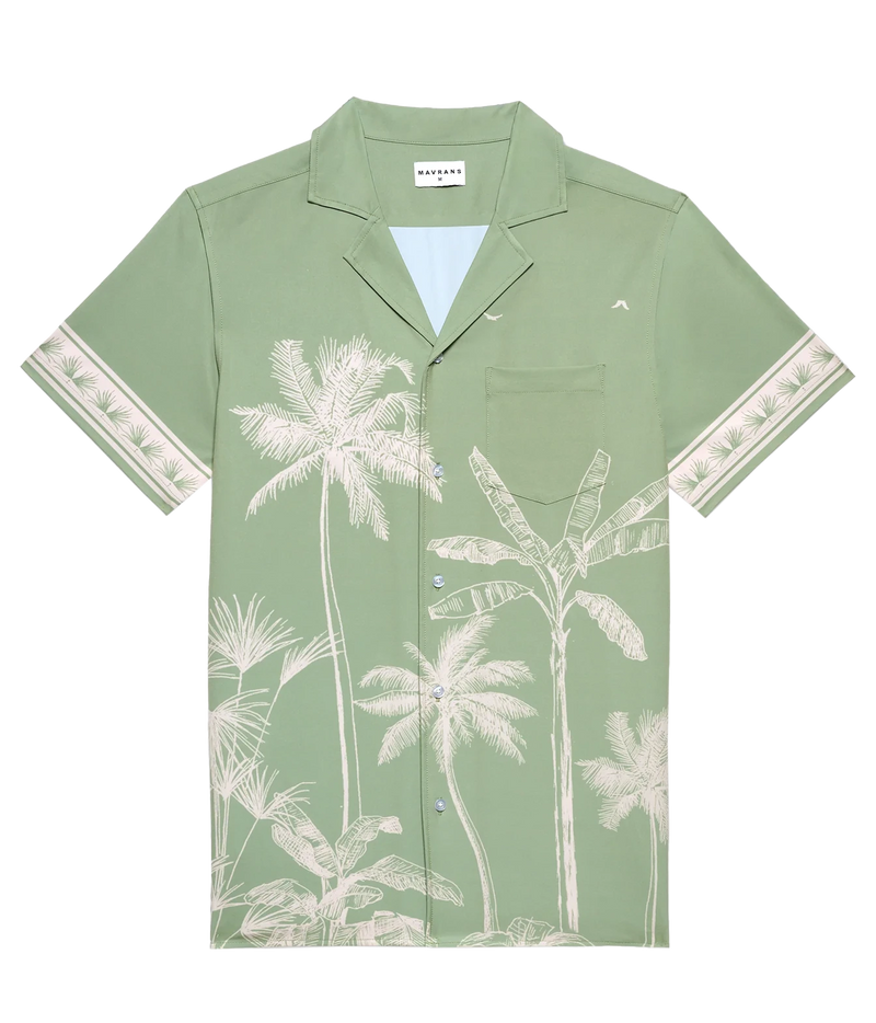 A sage green short-sleeve camp collar shirt with a white palm tree and tropical leaf print, featuring patterned cream cuffs and a chest pocket.
