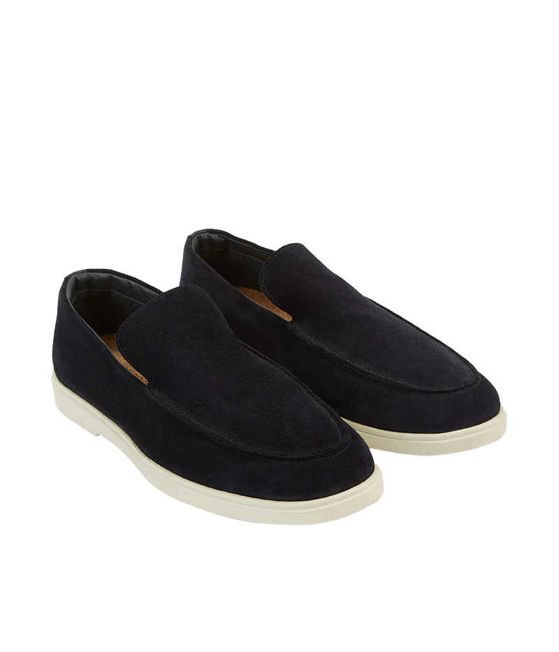 The Miguel Loafer in navy suede is a timeless summer essential, combining supple leather with effortless style. Designed for all-day comfort, it features a 100% recyclable thermoplastic rubber sole for durability and sustainability. A versatile warm-weather staple, perfect for pairing with linen trousers or tailored shorts.