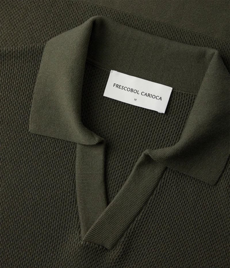 Close-up of a Frescobol Carioca Rino Short Sleeve Cotton Polo in Cove Green with a white neck label reading 'FRESCOBOL CARIACA'.