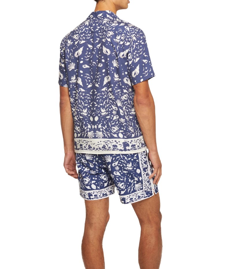 Orlebar Brown Maitan Shirt featuring an artistic maritime print with shells, seagulls, sailboats, and marine life. The short-sleeved shirt includes a Capri collar, hidden button placket, and slit hem for a clean silhouette. Made from 100% Lyocell, machine washable at 30°C.