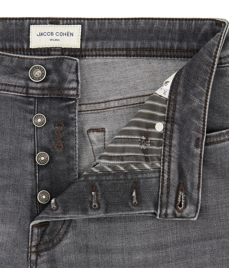 Close-up of a gray denim jacket or overshirt by Jacob Cohen, showing the buttoned front, inner pocket flap, striped lining, and metal snap details against a white background.