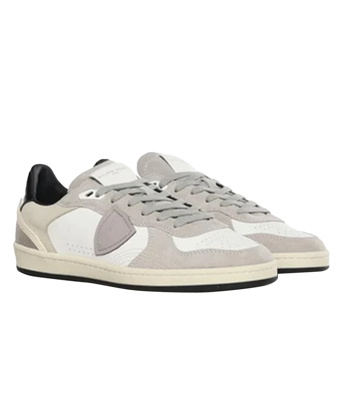 A pair of low-top sneakers in light gray, white, and beige suede and mesh, featuring a signature shield logo on the side, shown against a plain white background.