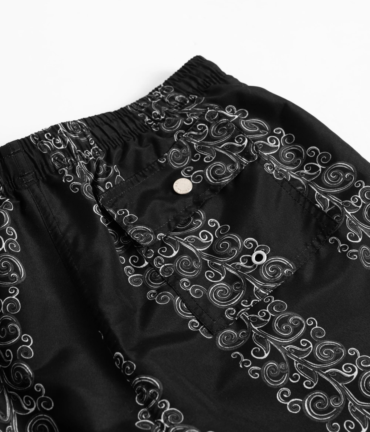 Close-up of snap-closure rear pocket on Bather Black Fiesta Swim Trunk in Black