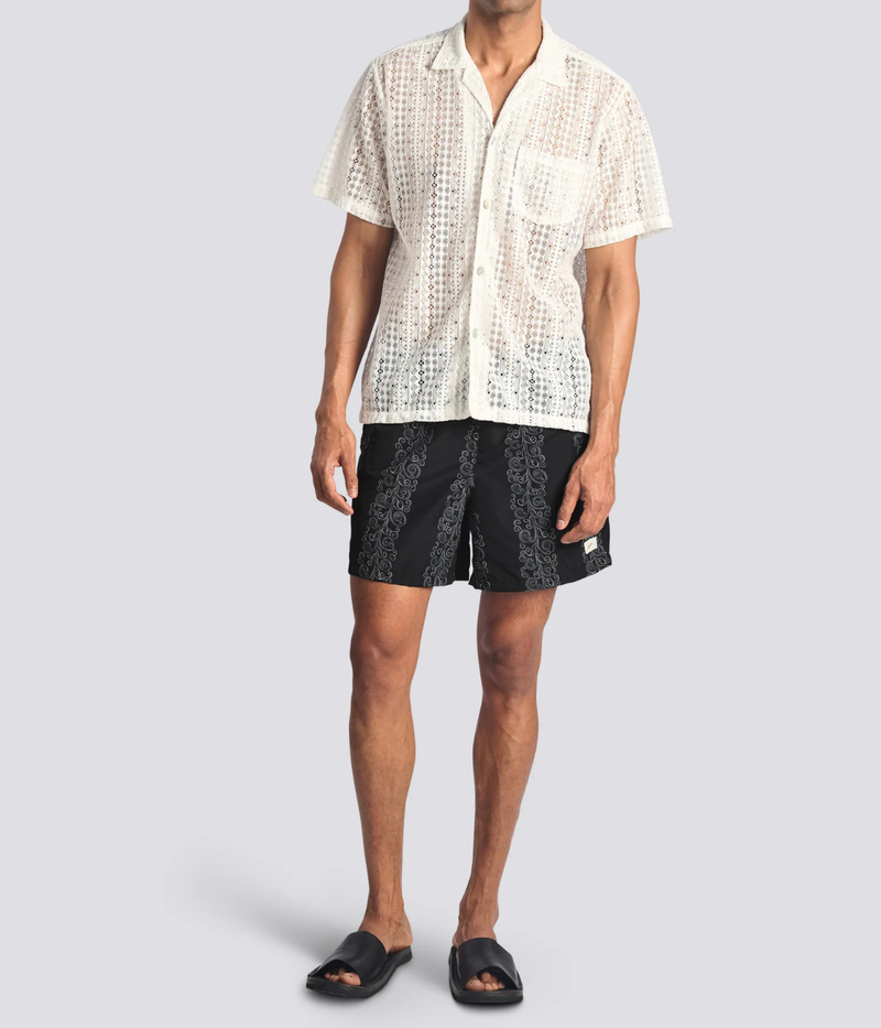 Model wearing Bather Black Fiesta Swim Trunk in Black featuring the Fiesta print and 5.5-inch inseam