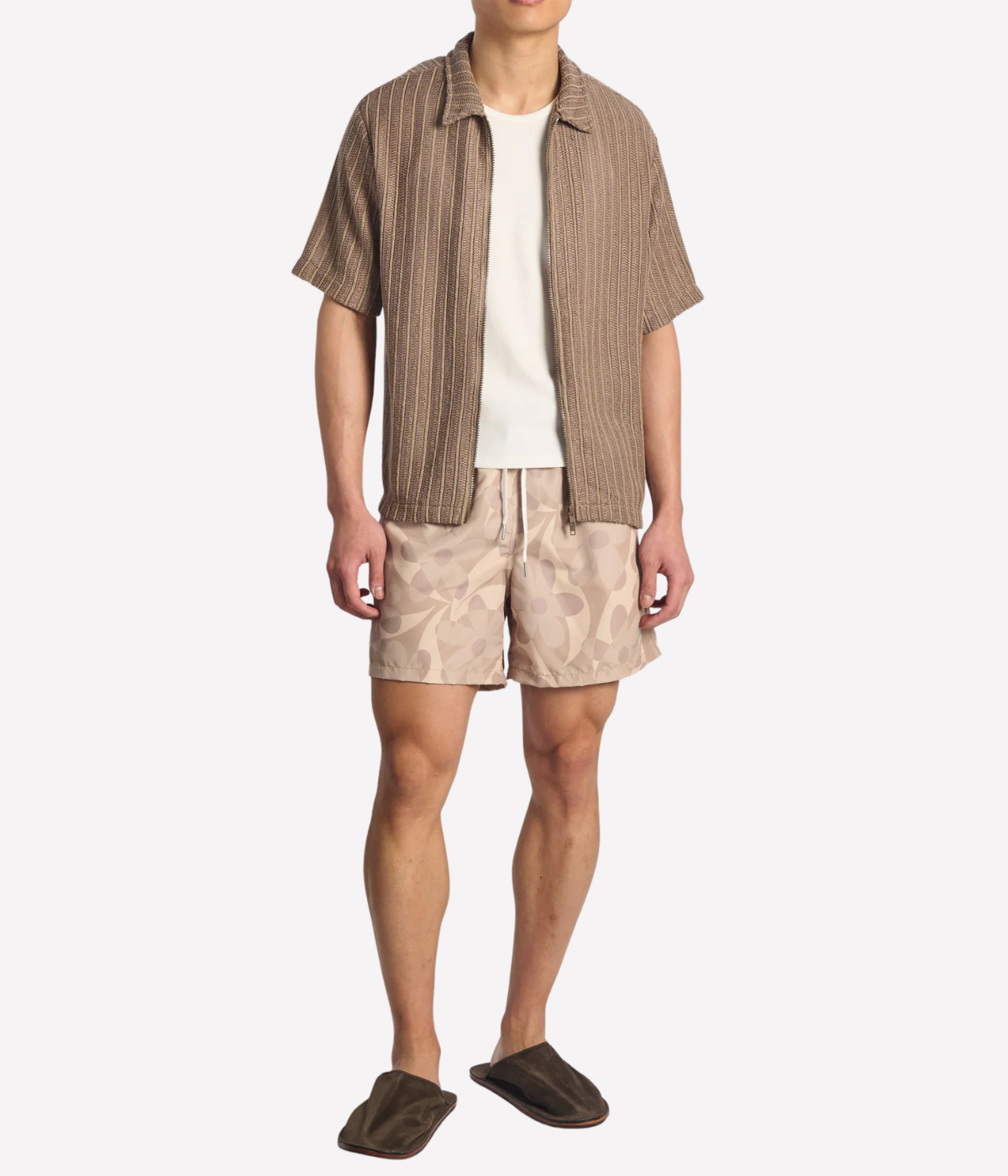 Bather Birch Daisy Trip Swim Trunk in Natural - full length front view on model featuring an earthy floral print and 5.5-inch inseam