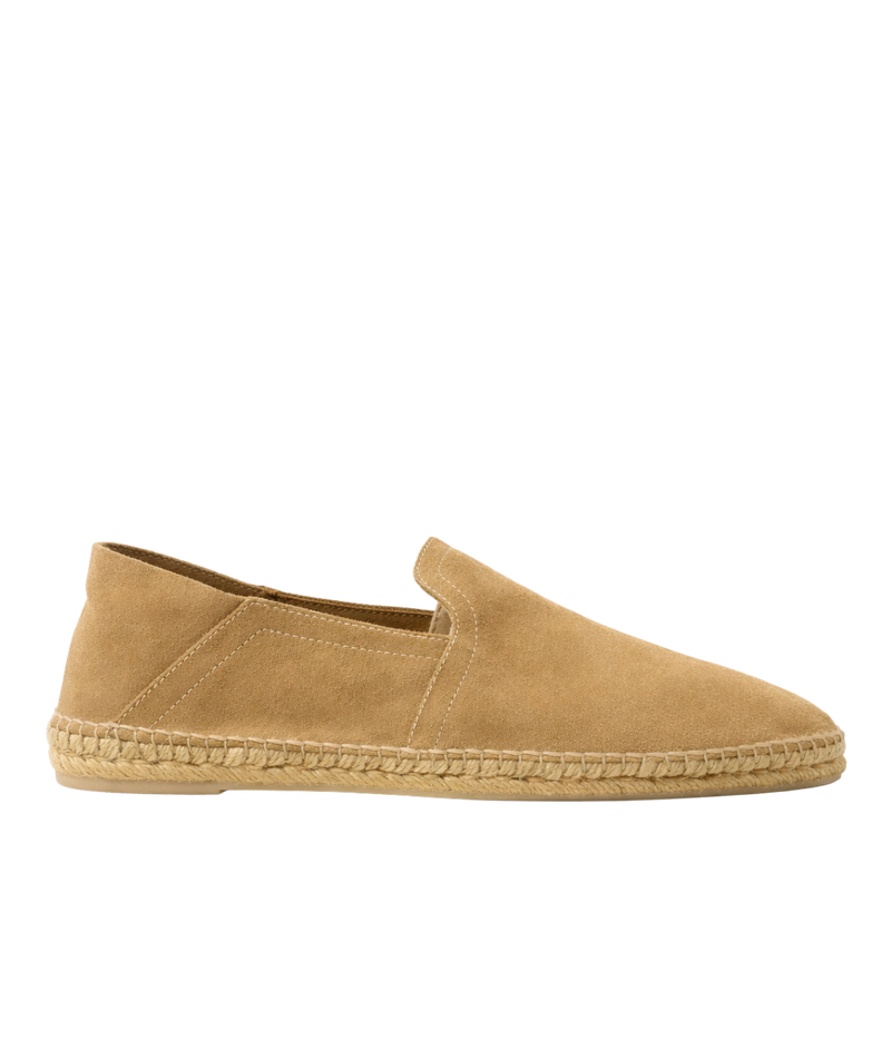Tan espadrille shoe on a white background
