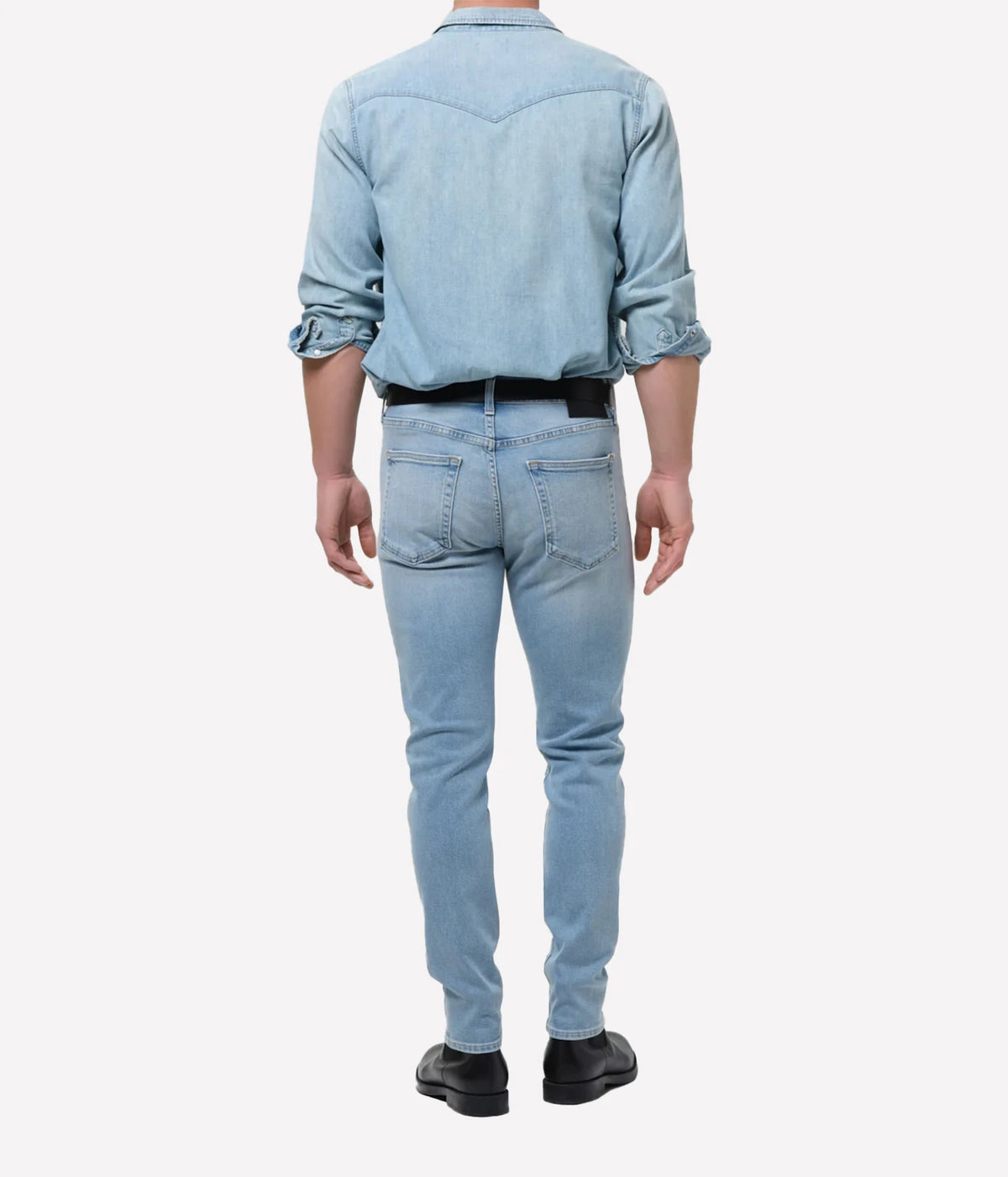 Man wearing Citizens of Humanity London Tapered Slim Perform Jean in Light Wash with a denim shirt, back view