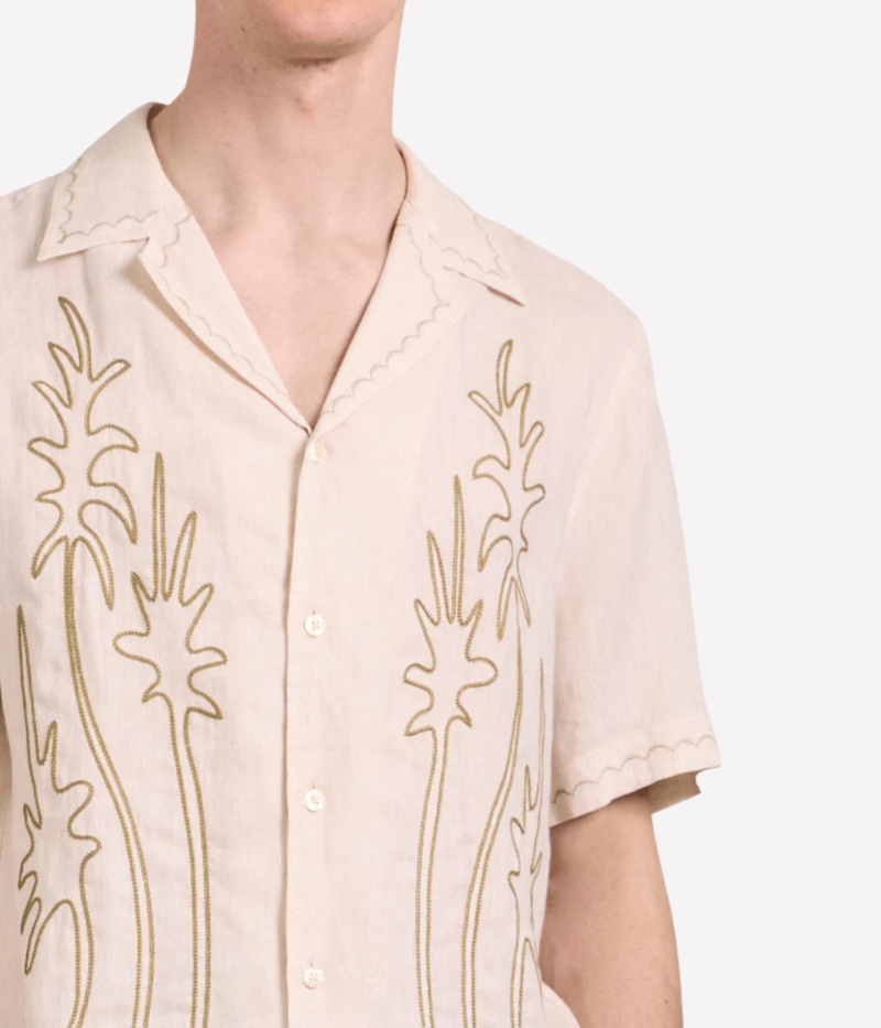 Frescobol Carioca Alves Palm Embroidered Linen Short Sleeve Shirt in Cream featuring seasonal palm embroidery, a camp collar and chest pocket - Close Up Front View on Model