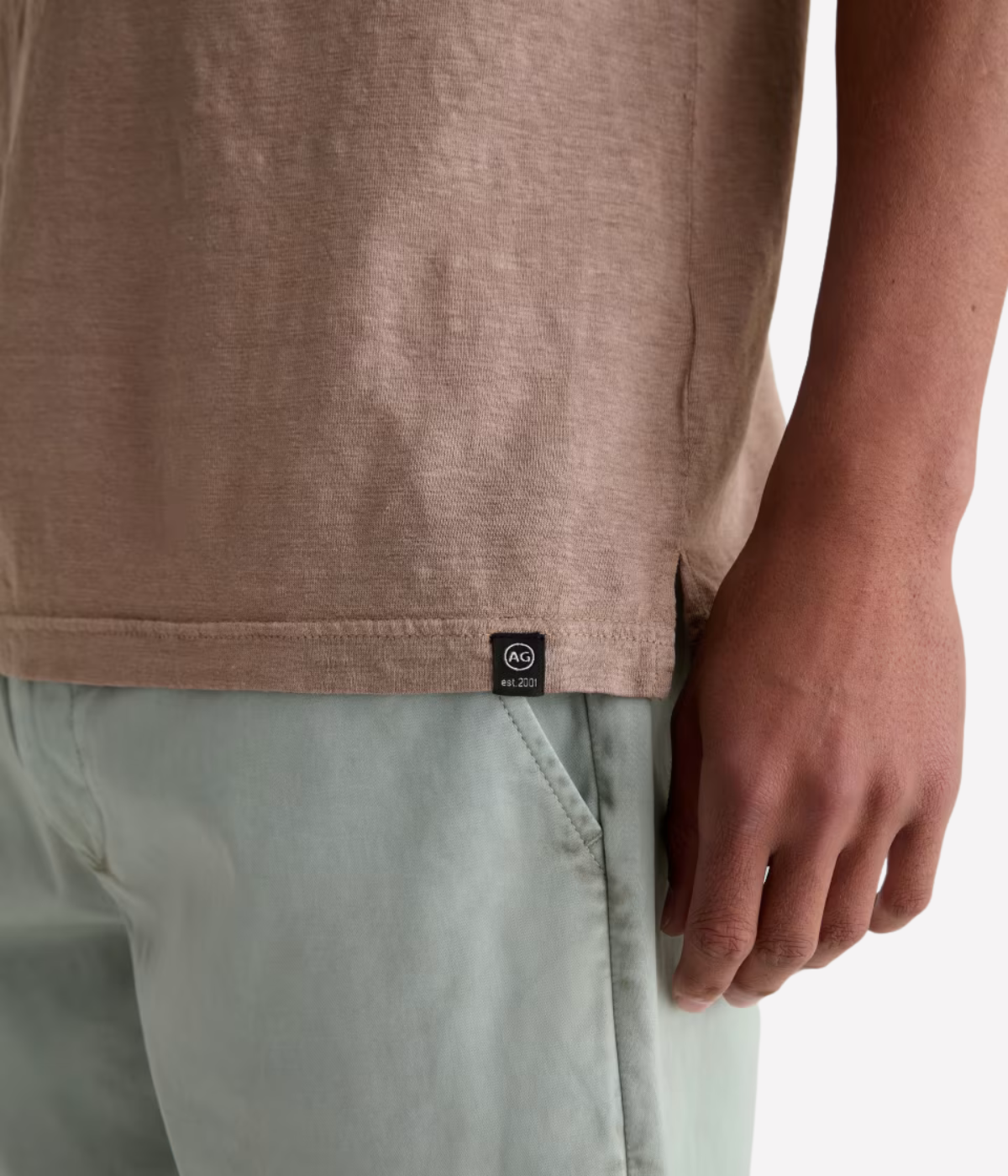 AG Bryce Short Sleeve Polo in Cork worn on model close up on logo label. 