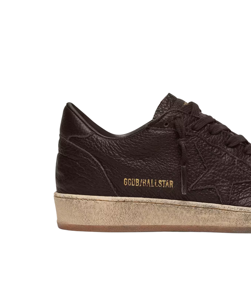 Golden Goose Ball Star low-top sneakers in dark brown leather with tonal leather star and vintage-inspired sole, close up.