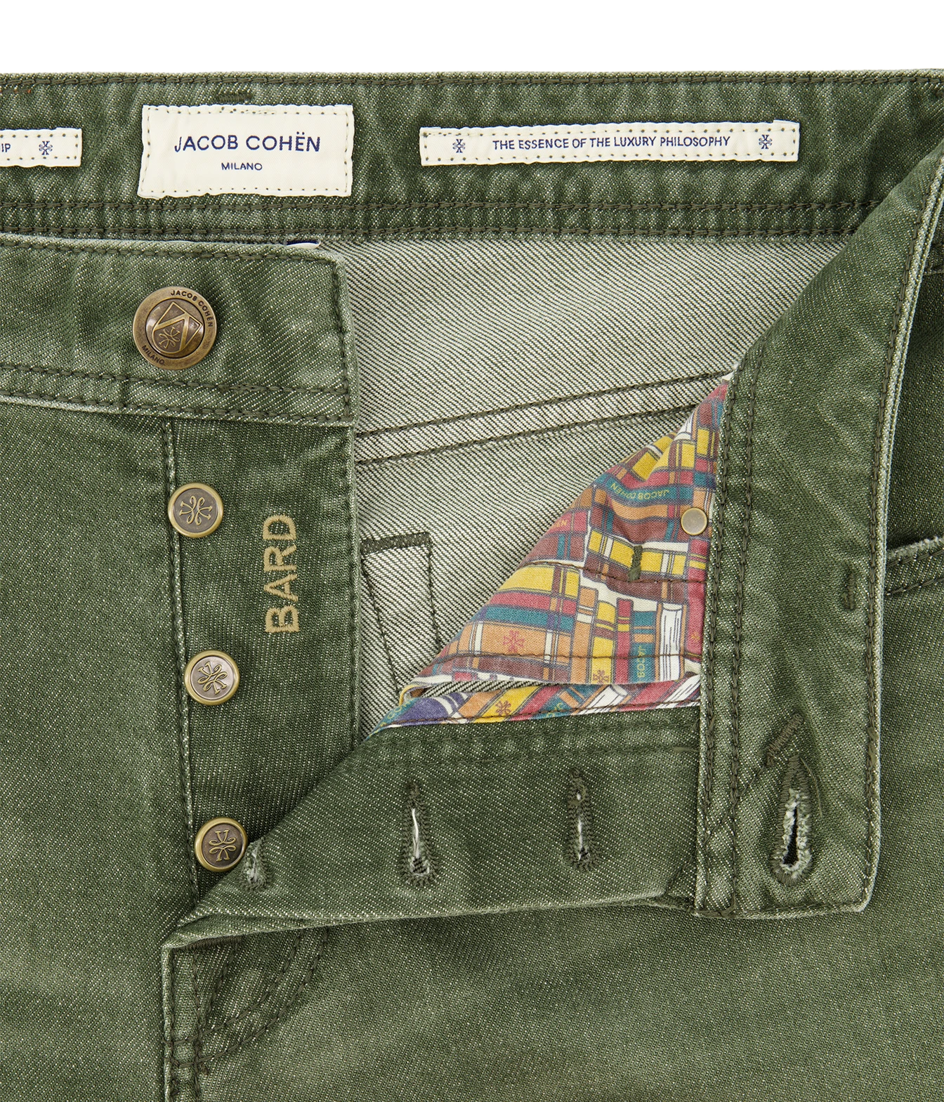 Close-up of olive green denim shorts by Jacob Cohén, showing the waistband, button closure, and a colorful plaid lining visible inside the waistband.