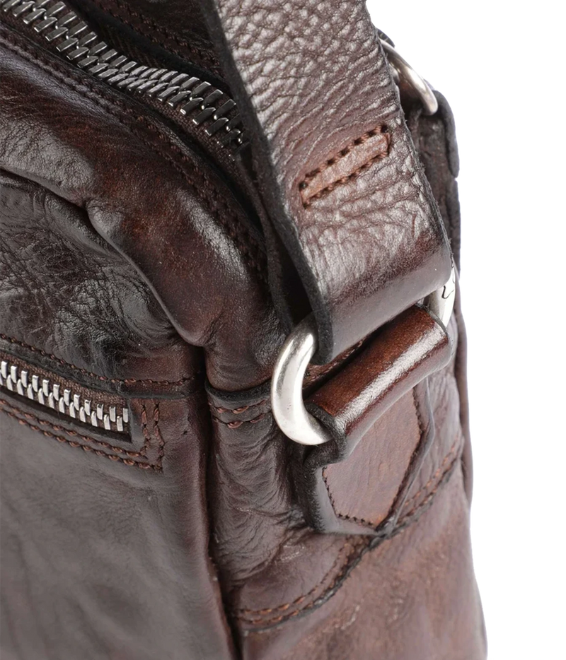 Close-up of Campomaggi Fico Small Crossbody Bag in Brown showing the zip pull and silver-tone fittings