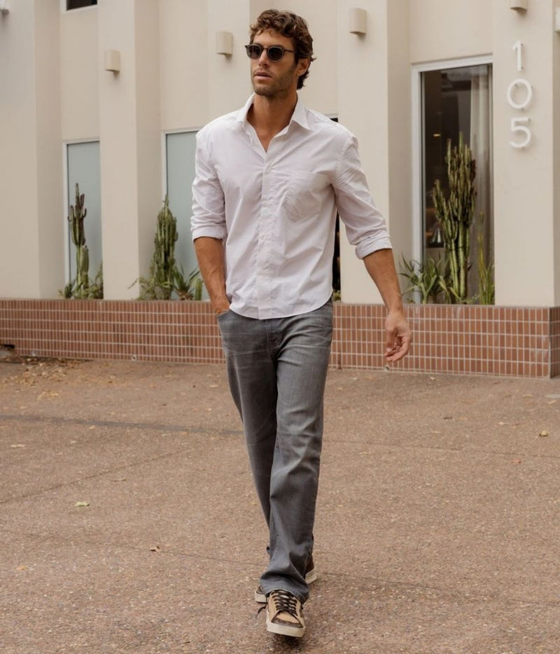 Full-length view of model wearing Lardini Cotton Pocket Shirt in Beige Stripe with jeans, walking outdoors