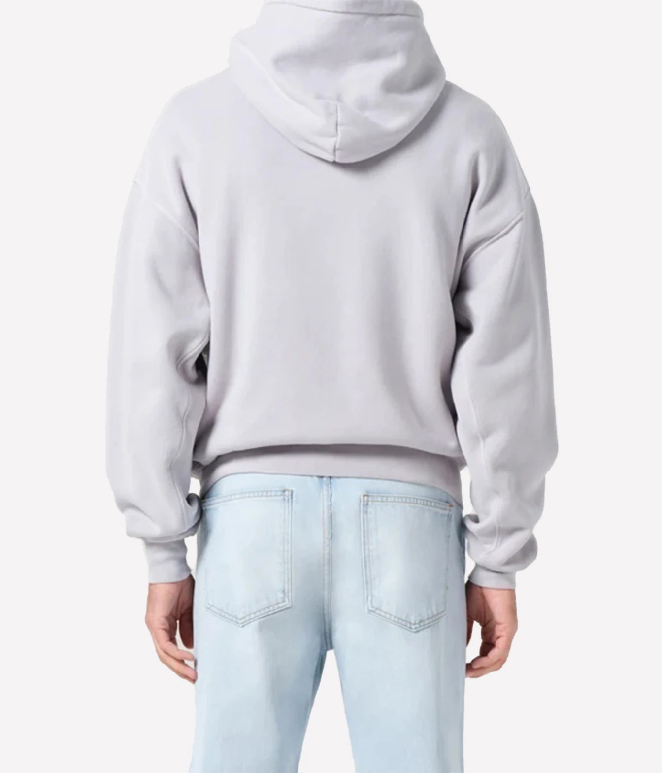 A person shown from the back wearing a light gray cropped hoodie and light blue jeans against a plain light gray studio background.