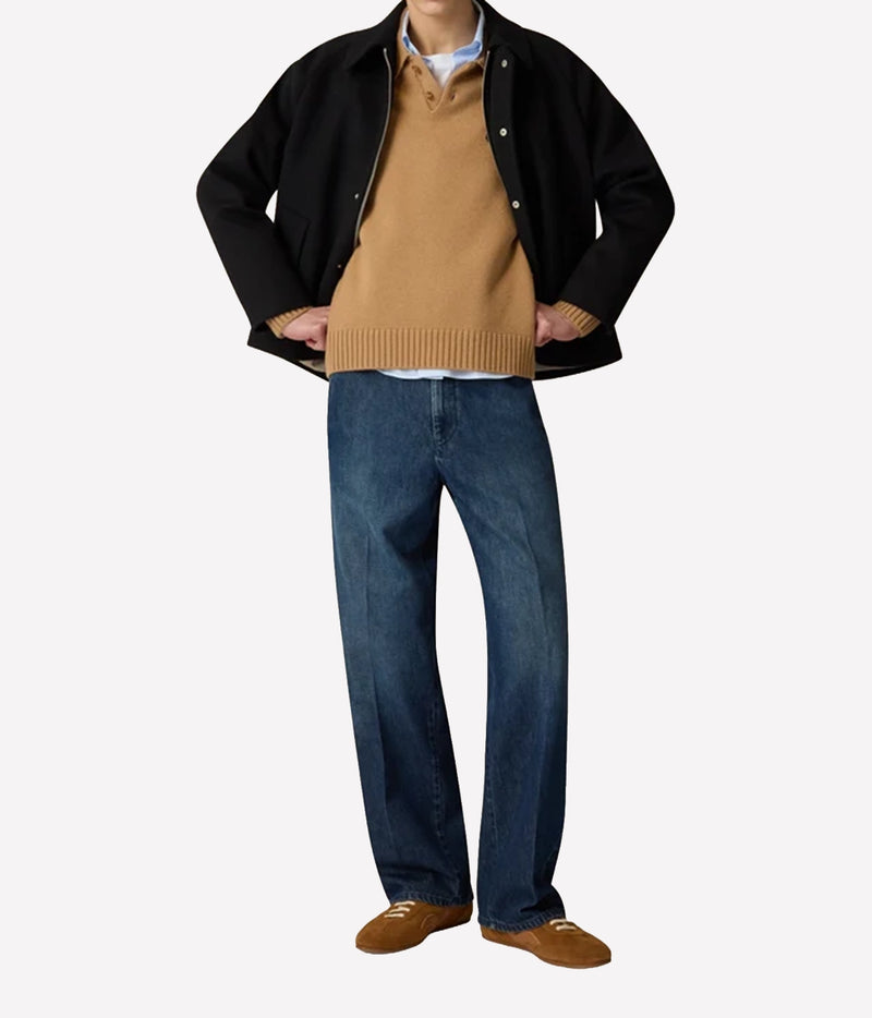 Man wearing Lardini Wool Cashmere Knit Polo in Beige under a black jacket with blue jeans and brown shoes, full-length front view