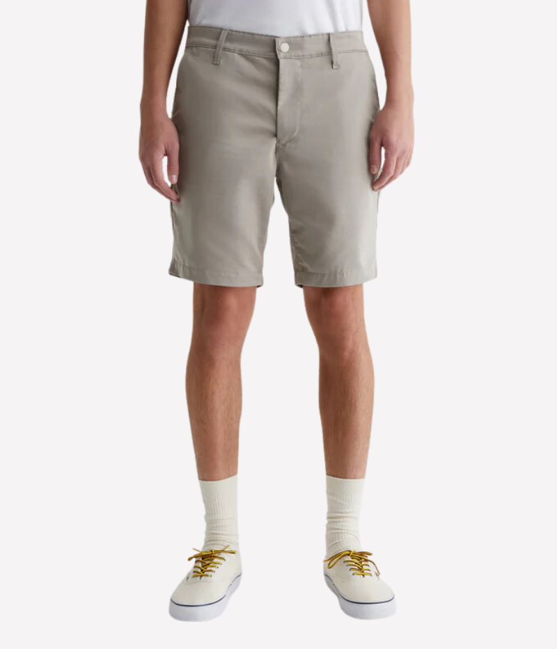 Front view of AG Wanderer Shorts in Dry Dust, showcasing the slim fit, light khaki shade, and clean trouser-style design.