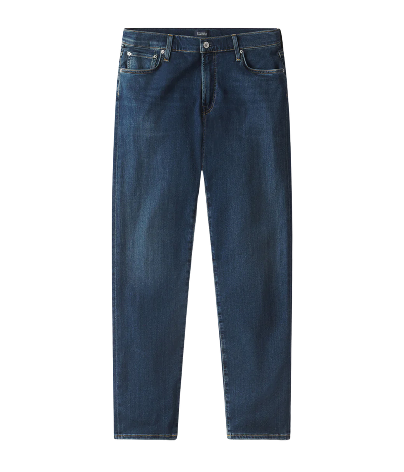 Men’s slim straight dark indigo jeans with subtle fading and whiskering, featuring a tailored fit and lightweight stretch denim made from regenerative cotton.
