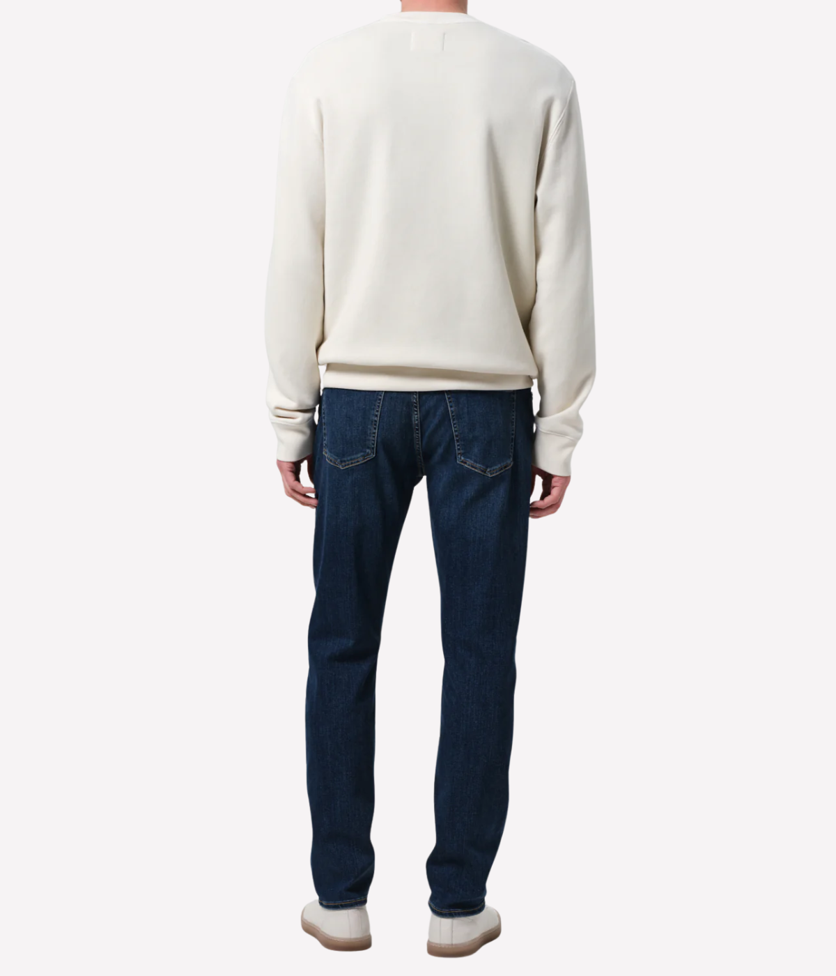 Men’s slim straight dark indigo jeans with subtle fading and whiskering, featuring a tailored fit and lightweight stretch denim made from regenerative cotton.