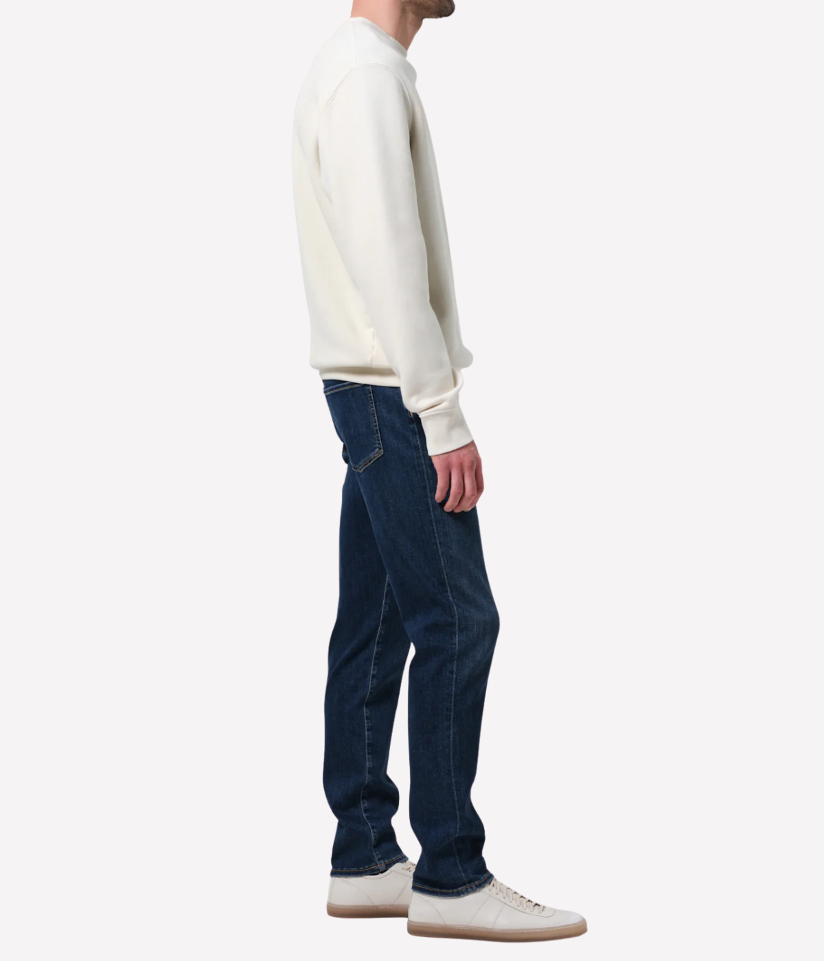 Men’s slim straight dark indigo jeans with subtle fading and whiskering, featuring a tailored fit and lightweight stretch denim made from regenerative cotton.