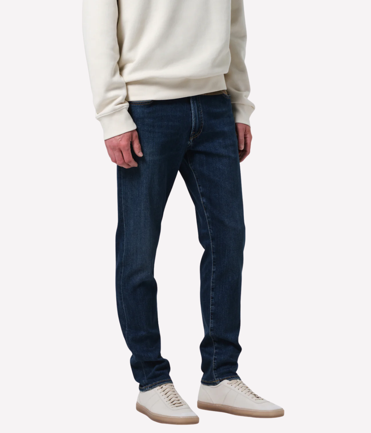 Men’s slim straight dark indigo jeans with subtle fading and whiskering, featuring a tailored fit and lightweight stretch denim made from regenerative cotton.