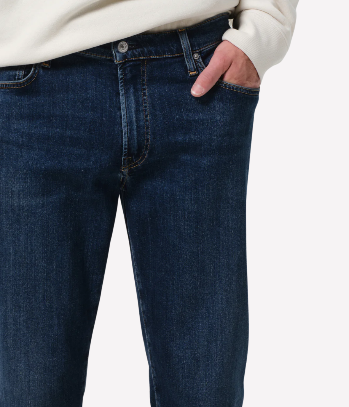 Men’s slim straight dark indigo jeans with subtle fading and whiskering, featuring a tailored fit and lightweight stretch denim made from regenerative cotton.
