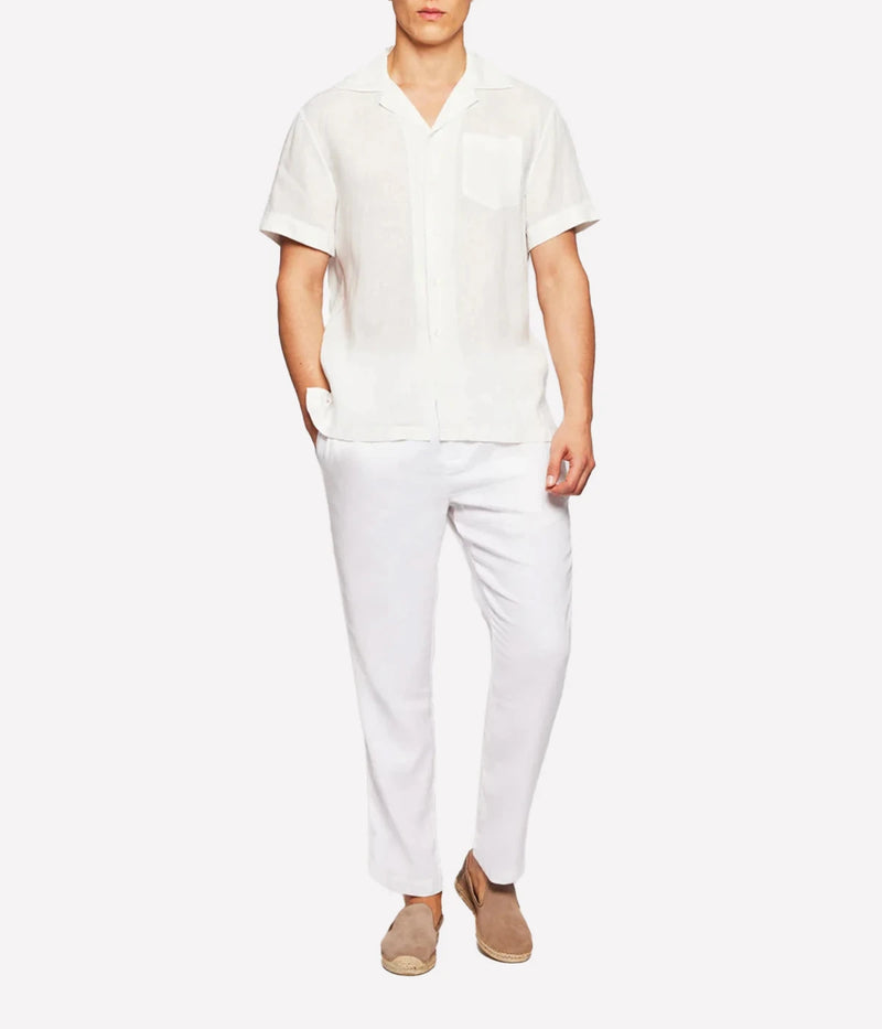 A relaxed-fit Angelo Shirt by Frescobol Carioca in lightweight Italian linen. Features a camp collar, chest pocket, and breathable fabric for effortless warm-weather style. Made in Portugal.