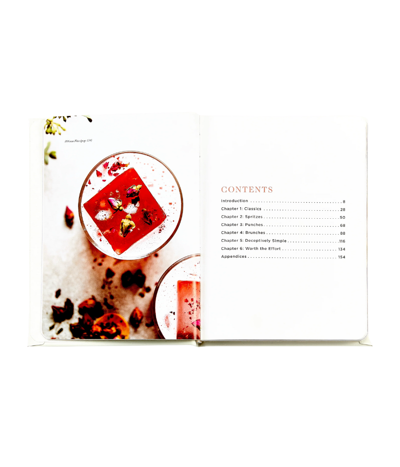 Luxury cocktail recipe book, gold foil hardcover with rounded corners, featuring 176 pages of champagne-based recipes, tips, and vibrant photography.