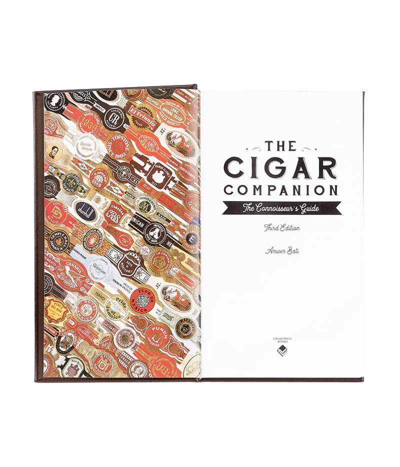 Luxury guide to handmade cigars, featuring 224 pages on cigar history, brands, and tasting techniques with full-colour photography.