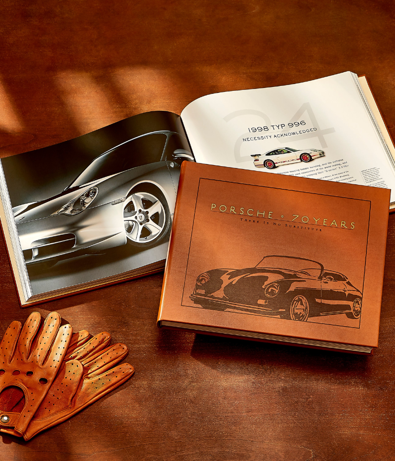 Luxury book on Porsche’s 70-year history, hand-bound in bonded leather, featuring 256 pages of rare images, iconic cars, and milestone events.