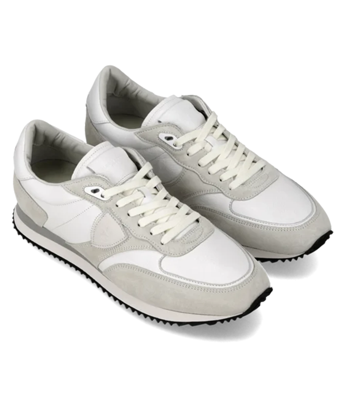 A pair of low-top sneakers in white and light gray suede and leather, featuring white laces and a black treaded outsole, shown on a white background.