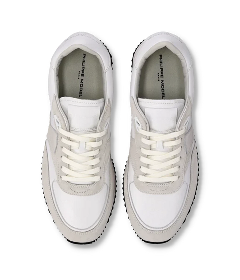 A pair of white and light gray low-top sneakers shown from a top-down view on a plain white background. The brand name 'PHILIPPE MODEL PARIS' is printed on the inner sole of each shoe.