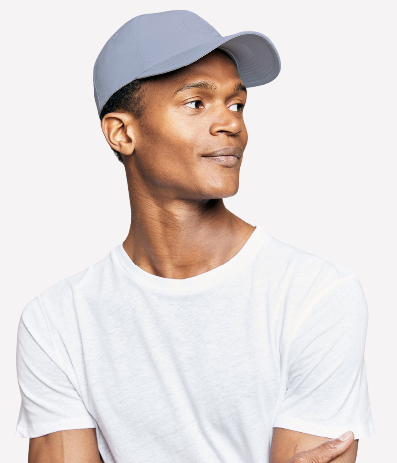 Model wearing the Frescobol Carioca Artur Beach Cap, styled for a relaxed, effortless look while enjoying sunny days.